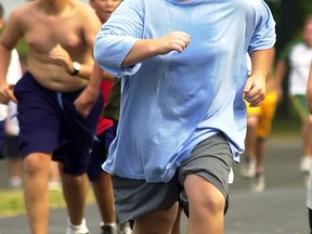 Participants run up a hill during a morning exercise session