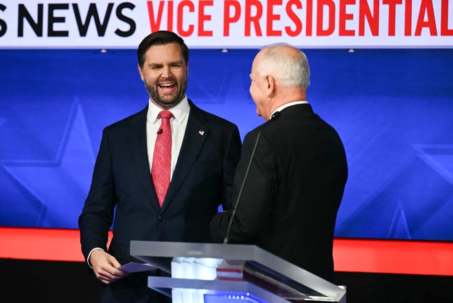 US Senator and Republican vice presidential candidate JD Vance (L) and Minnesota Governor and Democratic vice presidential candidate Tim Walz shake hands at the end of the Vice Presidential debate hosted by CBS News at the CBS Broadcast Center in New York City on October 1, 2024.