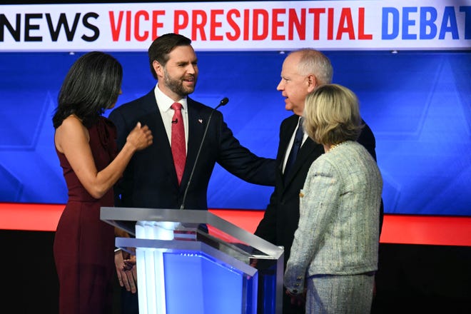 (L-R) US Senator and Republican vice presidential candidate J.D. Vance and his wife Usha Vance greet Minnesota Governor and Democratic vice presidential candidate Tim Walz and his wife Gwen Walz at the end of the Vice Presidential debate hosted by CBS News at the CBS Broadcast Center in New York City on October 1, 2024.