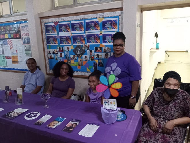 The Rev. Dr. Mary Mitchell, standing, pastor of Bartley Temple United Methodist Church, manned a table with members of her family sharing information about dementia provided by the Alzheimer's Association during the Community Health Fair presented by Impact Duval.