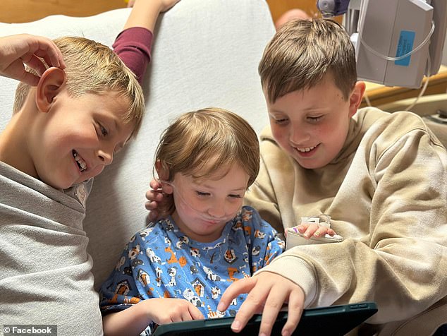 Alma Geddes, center, is pictured with her brothers as she stays in a Baltimore hospital where she was treated for Mycoplasma pneumonia
