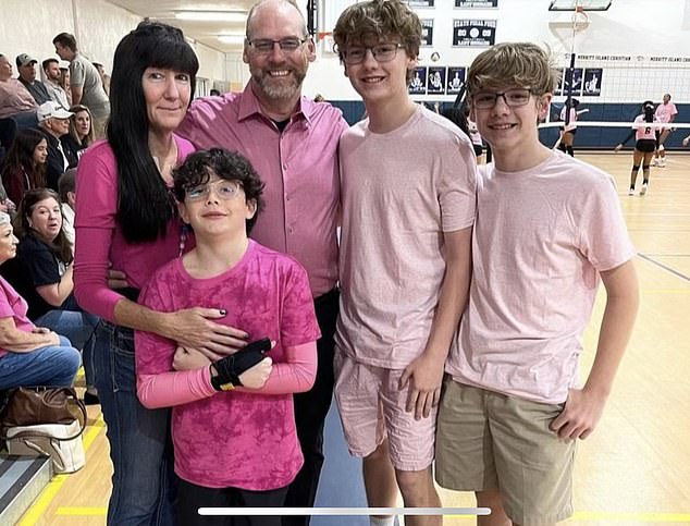 Dr Willits is now running a marathon for breast cancer. She is pictured above at a breast cancer awareness event