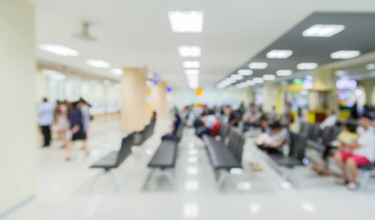 Blurred people waiting in a hospital ED. 