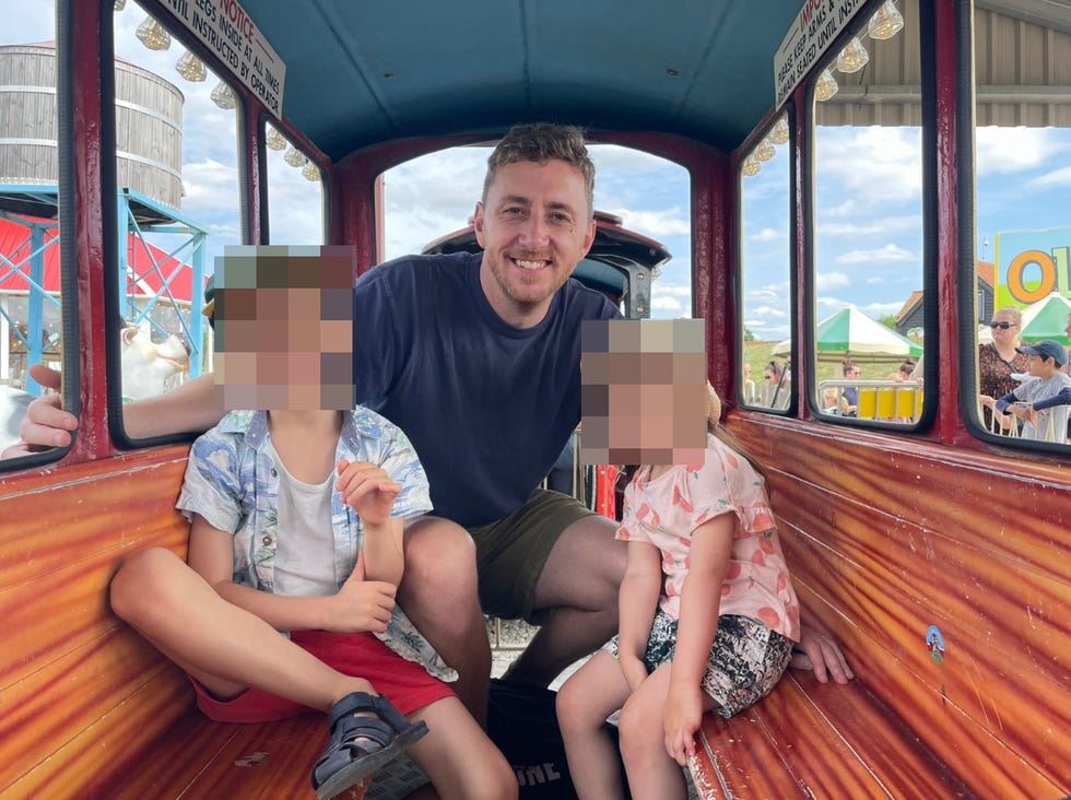 a group of children is sitting inside a train style ride