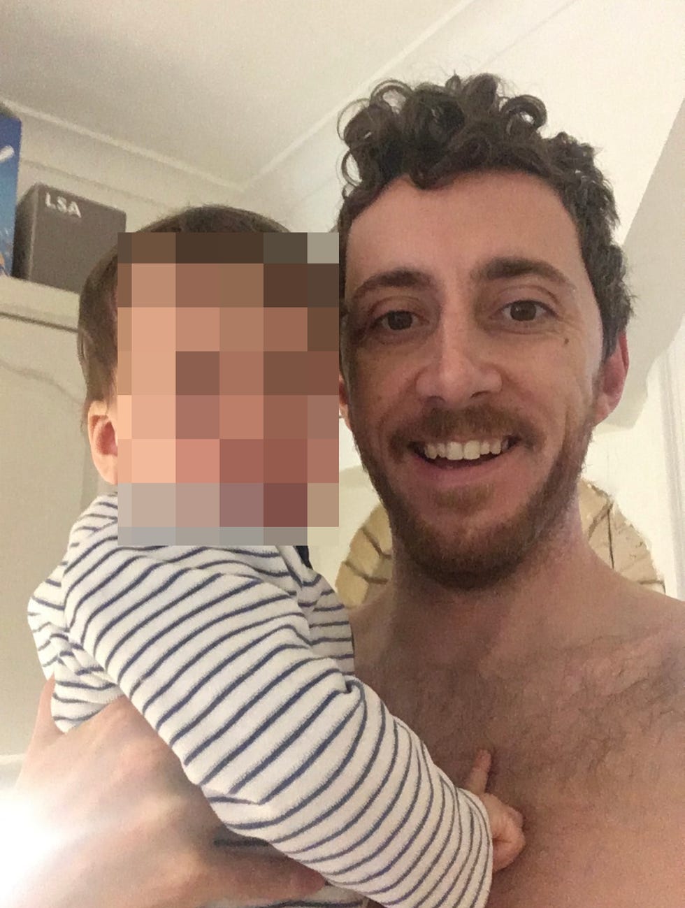 an adult is holding a small child close to their chest