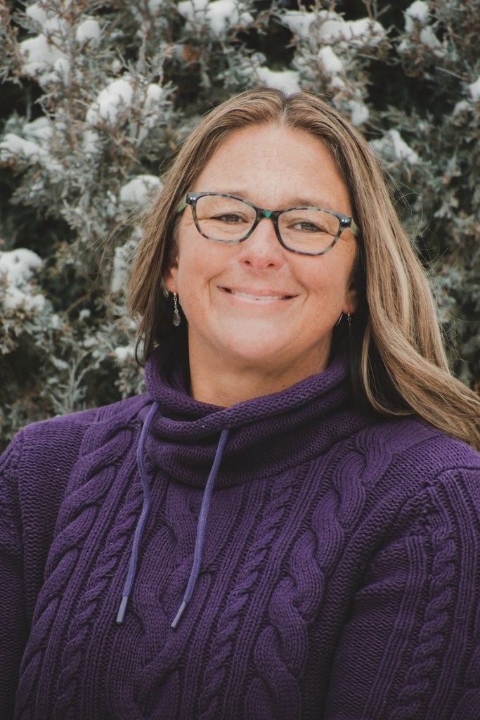 A woman stands outdoors in winter