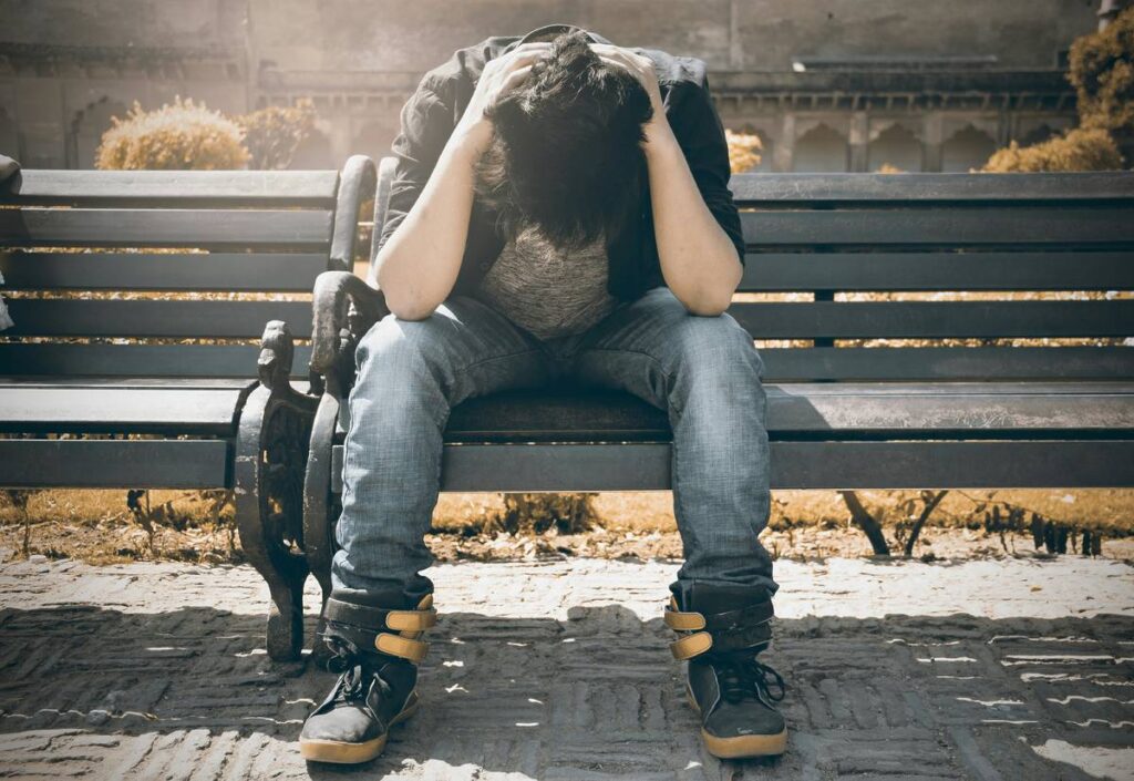 stessed man on a park bench