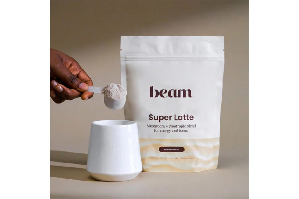 Person pouring powder into a cup