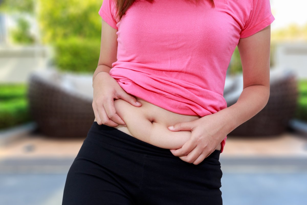 Woman holding her own belly fat