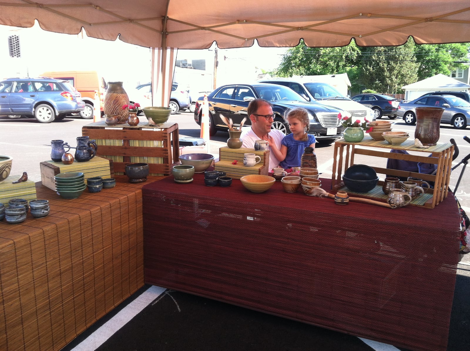 David Chesar with his daughter selling his clay works at an art fair. CONTRIBUTED
