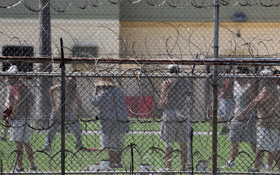 Federal inmates gather in prison yard