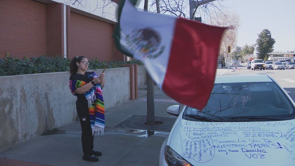 After leaving work early, Crystal Aguilar stands outside the Bakersfield Police Department waving Mexico's flag (KBAK/FOX58){ }