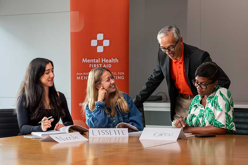 adults learn mhfa from an instructor in a group