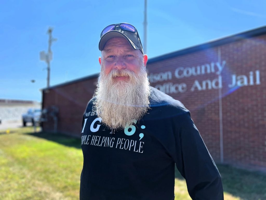 Ohio veteran Dirk Harkins  stands outside of a brick building