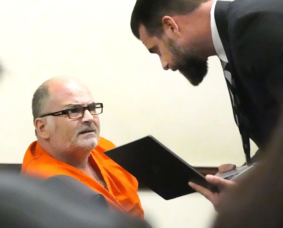 Travis McBride, a DeLand therapist accused of killing a homeless man, talks with his attorney Bryan Lambert, Wednesday January 15, 2025 during a hearing before Circuit Judge Karen Foxman at the Justice Center in Daytona Beach.