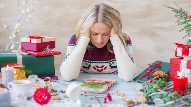 Exhausted And Overwhelmed Woman Packing Christmas Gifts