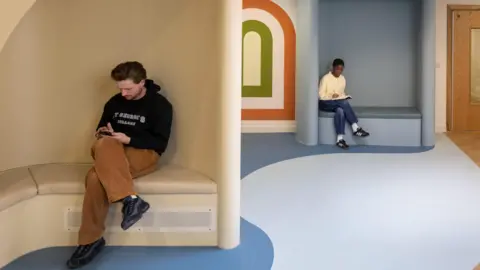 Fleet Architects/Fernando Manoso A design interpretation showing the interior of The Sett with two people sitting in booths.