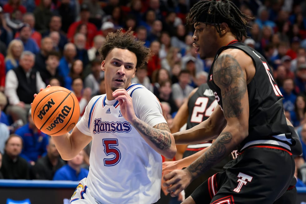 Kansas guard Zeke Mayo (5) drives around Texas Tech forward JT Toppin (15) during the first...