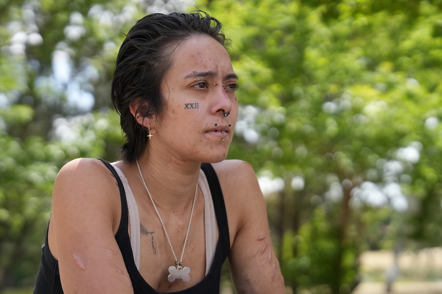 A woman looks seriously towards the distance.