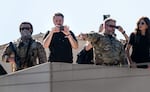 Conservative influencer Nick Sorter, center left, takes images from atop the U.S. Immigration and Customs Enforcement (ICE) facility on Oct. 7, 2025, during a visit by U.S. Homeland Security Secretary Kristi Noem.