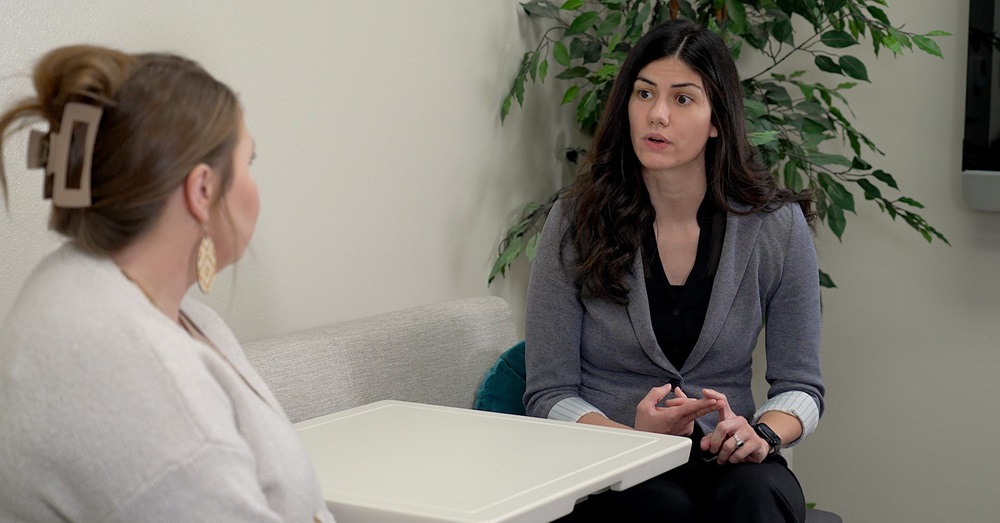 Two women talking across a table