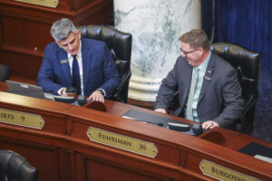 Rep. John Shirts, R-Weiser, talks with Rep. Ben Fuhriman, R-Shelley, on the House of Representatives floor