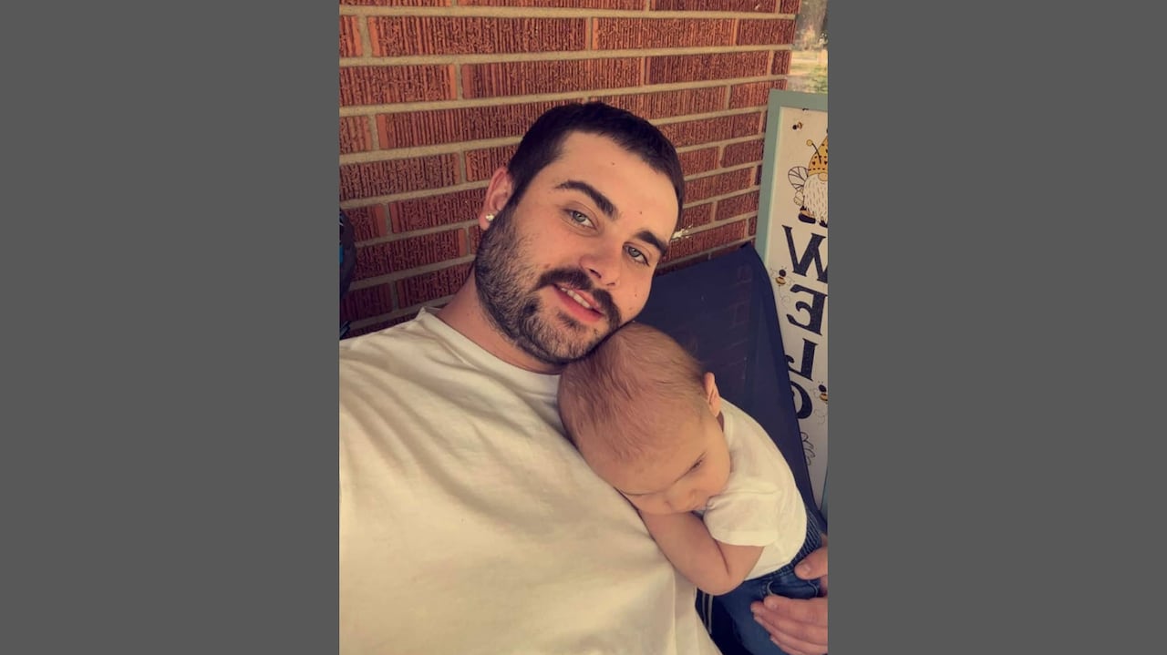 A man holding his infant son.