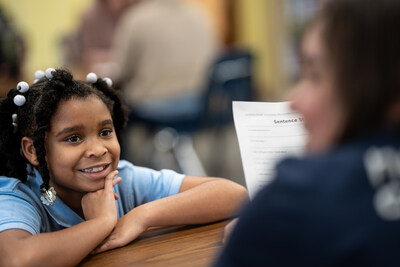 The Cigna Group Foundation blends financial support with volunteering opportunities for employees to deepen the impact of its community contributions. Pictured below, employee volunteers mentor elementary school youth in St. Louis.