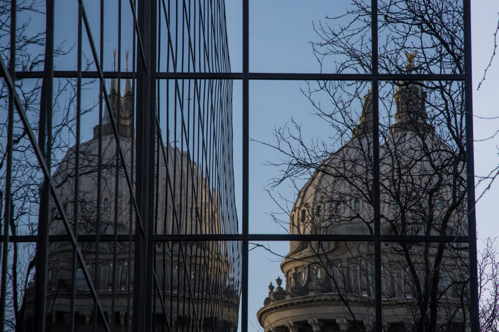 The Idaho State Capitol is reflected in the Joe R. Williams building