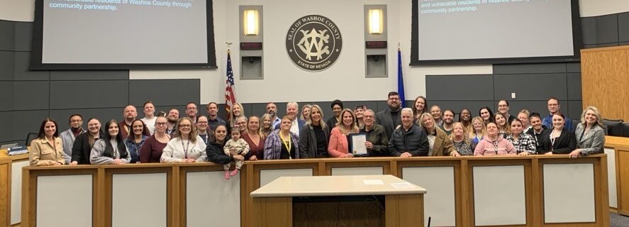 image a large group of people posing in front of the Washoe County logo.