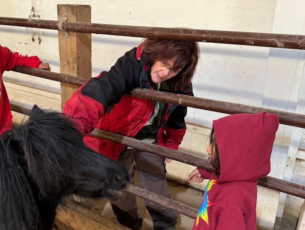 Bridget Williams introduces a child to a horse at Red Horse Healing in Rapid Valley, S.D., on...