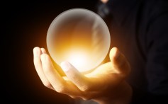 Businessman hand holding a Crystal Ball