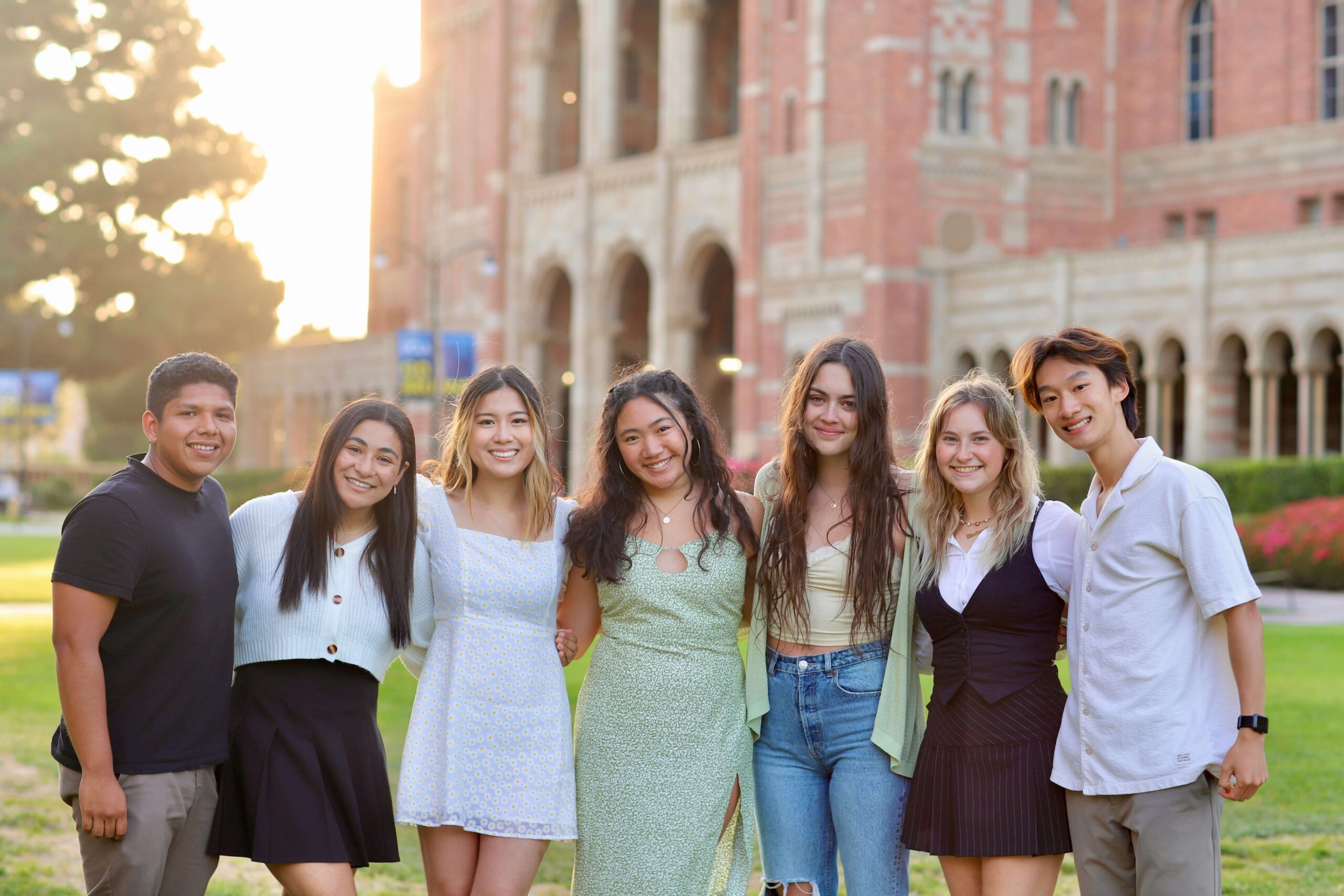 Teens stand in front of a school