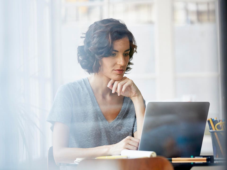 Businesswoman using laptop in office