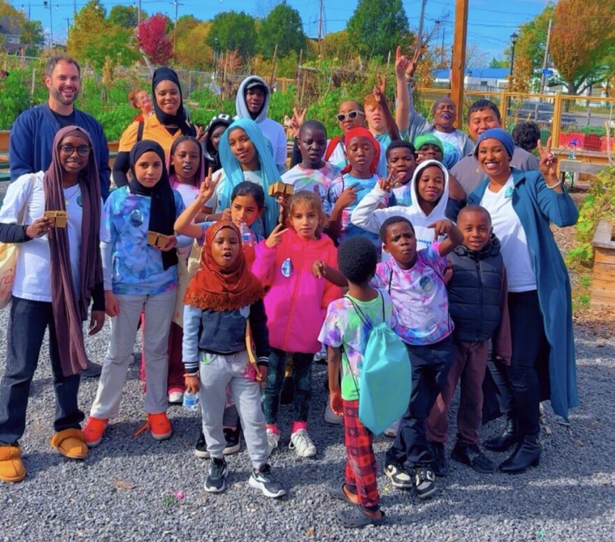 Hani Ali stands amid a group of children whom are a part of her mentorship program.