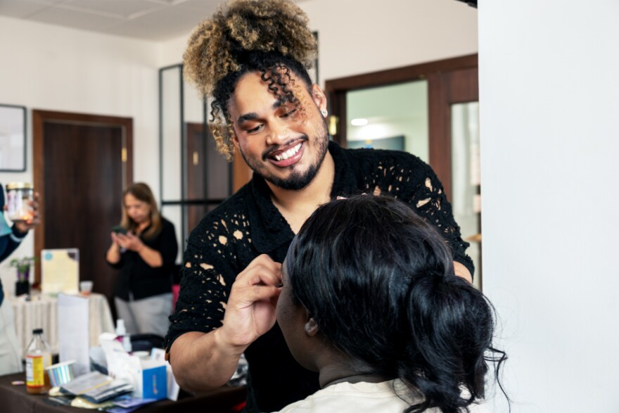 Luis Cruz applies false lashes on former Respira intern, Whitney Agyeman, who is now a psychotherapist, during Respira Counseling and Wellness's self-care retreat at S.P.L.A.S.H. Project in Hartford on March 7, 2026.