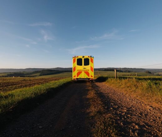 An ambulance driving through a rural area