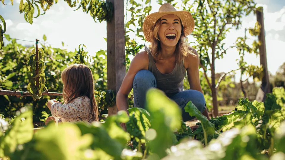 happy woman in the garden with her daughter