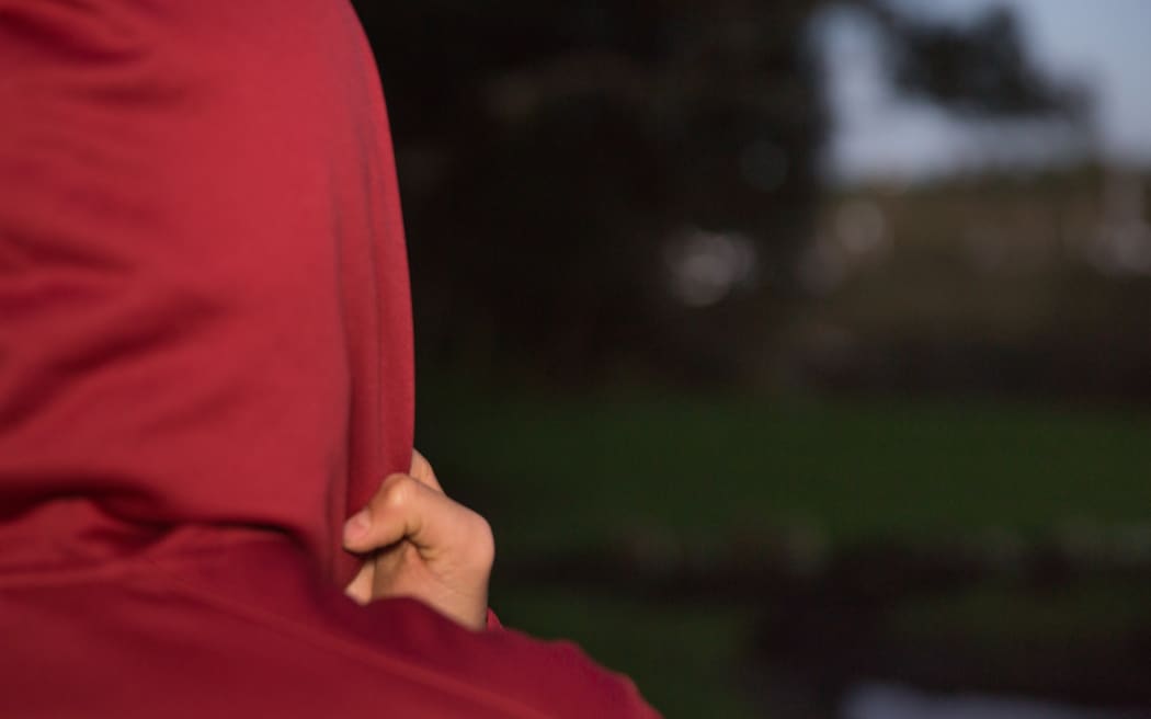 A teenage Māori boy looking unhappy