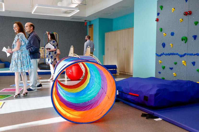 Guests tour a sensory gym in the Jewish Family Service of Dallas facility, Thursday, March...
