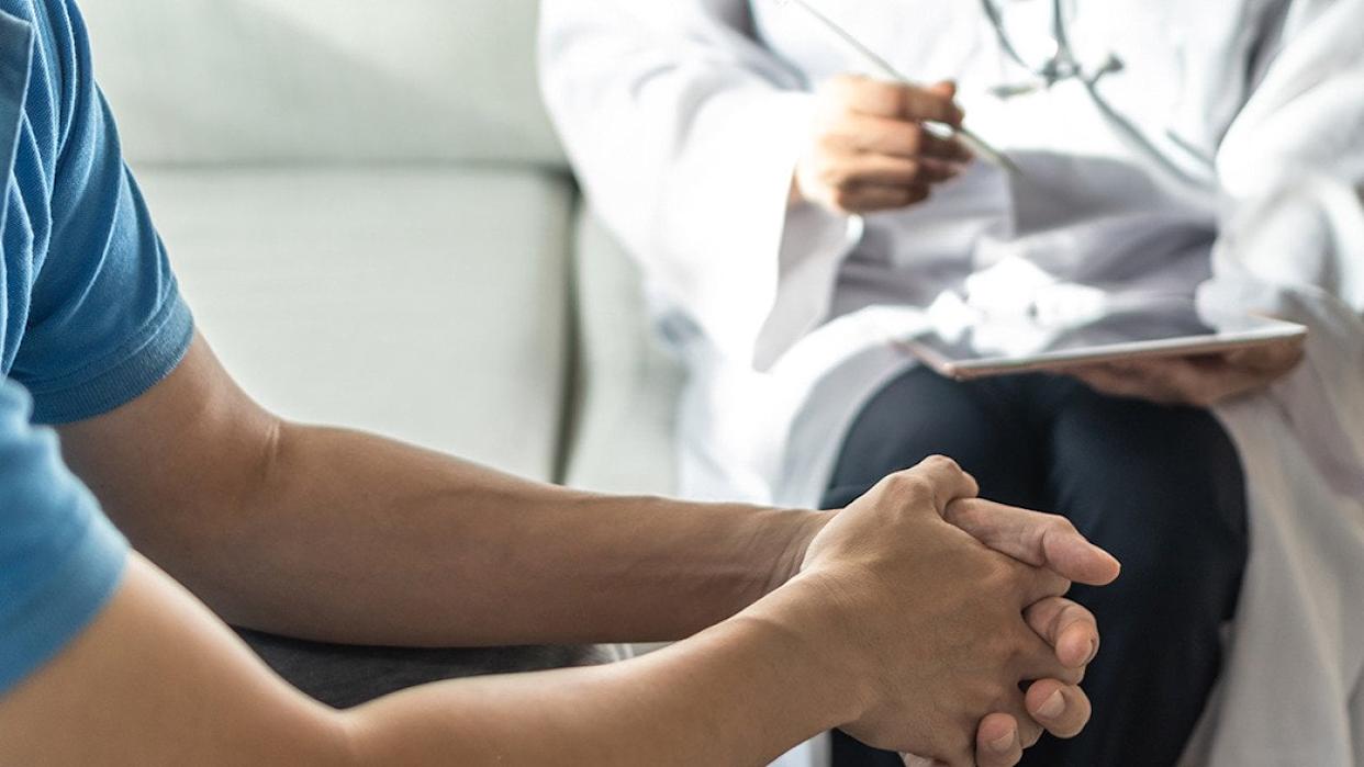 Man consulting with a doctor. - Chinnapong // Shutterstock