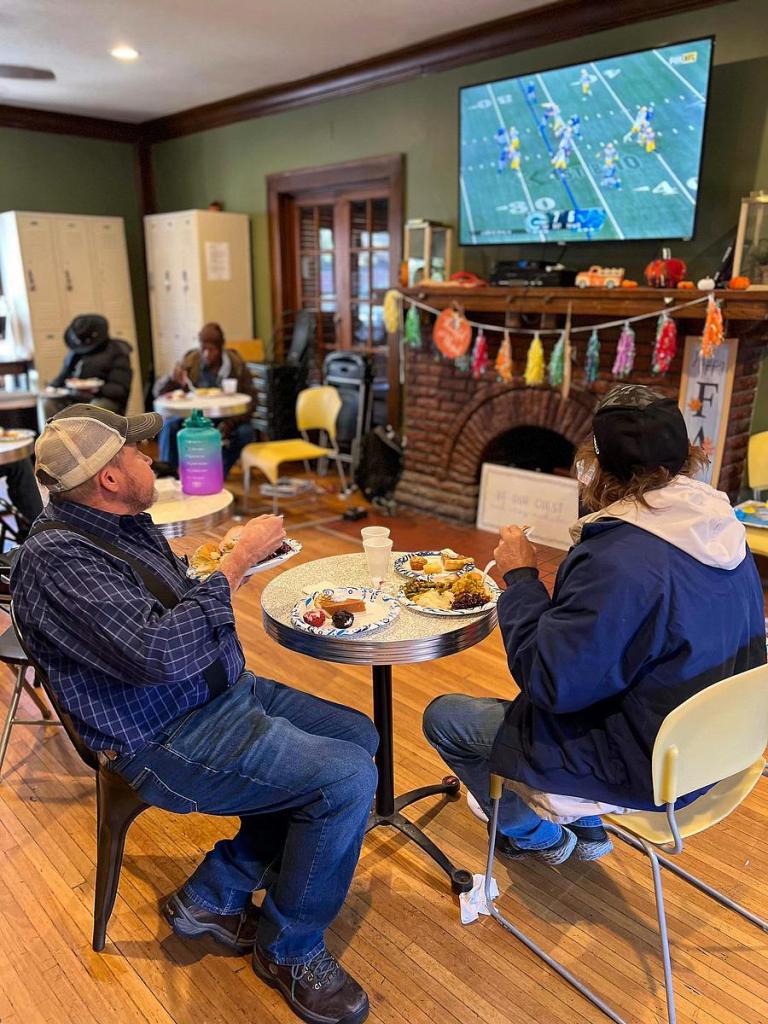 Clients at Mental Health Association Oklahoma's Denver House attend a 2023 Thanksgiving lunch.  The peer-run drop-in center in Tulsa serving adults experiencing mental illness or homelessness has sustained a 20% cut in state funding as a result of Oklahoma Department of Mental Health and Substance Abuse Services contract cuts.