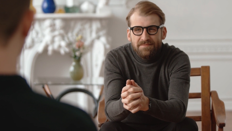 Man speaking with a therapist during a mental health services consultation