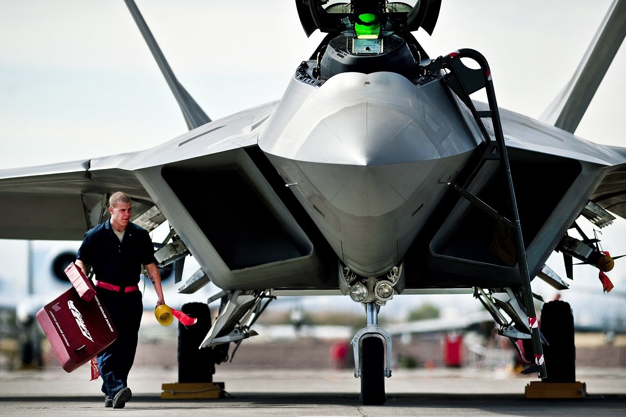 U.S. Air Force Airman 1st Class Jonathan Foster, 49th Aircraft Maintenance Squadron, crew chief, from Holloman Air Force Base, N.M. removes the intake covers of an F-22 Raptor before a training mission during Red Flag 11-3 at Nellis Air Force Base, Nev., March 2, 2011. Red Flag is a realistic combat training exercise involving the air forces of the United States and its allies. The exercise takes place north of Las Vegas on the Nevada Test and Training Range--the U.S. Air Force's premier military training area with more than 12,000 square miles of airspace and 2.9 million acres of land. (U.S. Air Force photo by Tech Sgt. Michael R. Holzworth/Released).