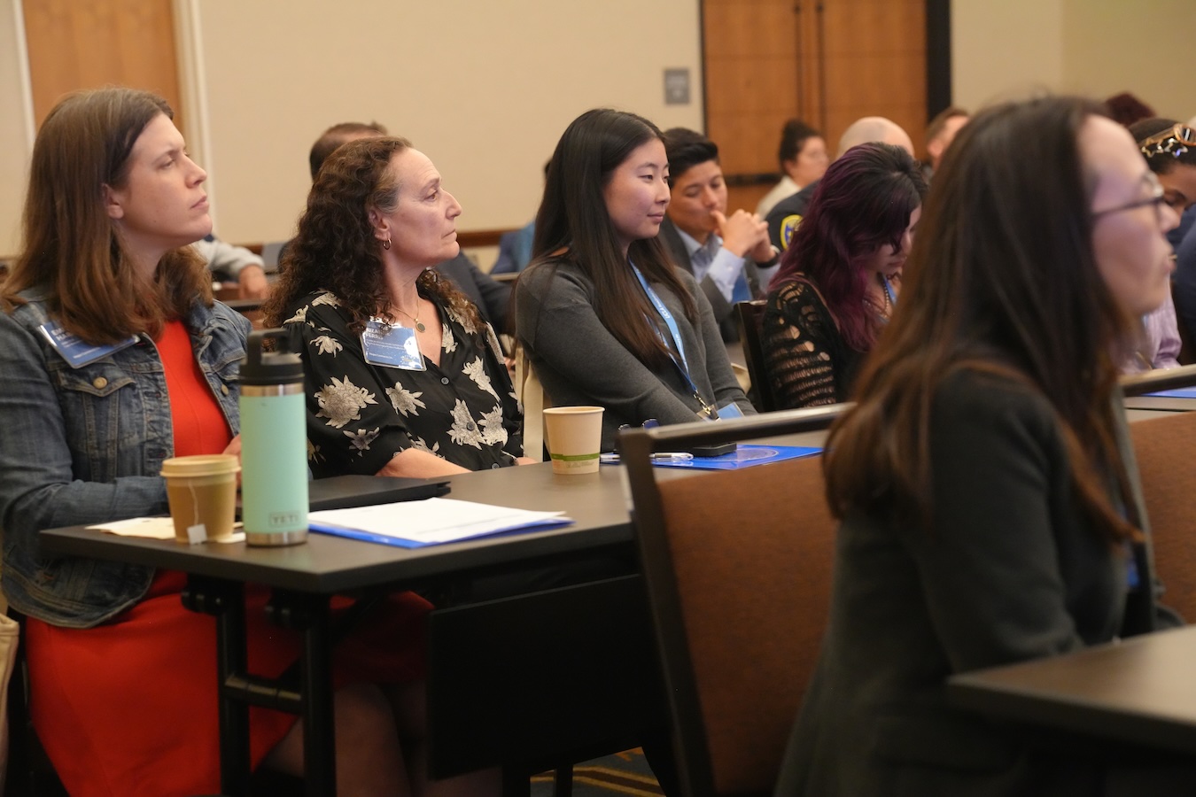 Hope connects us-four participants sitting at table listening to presentation