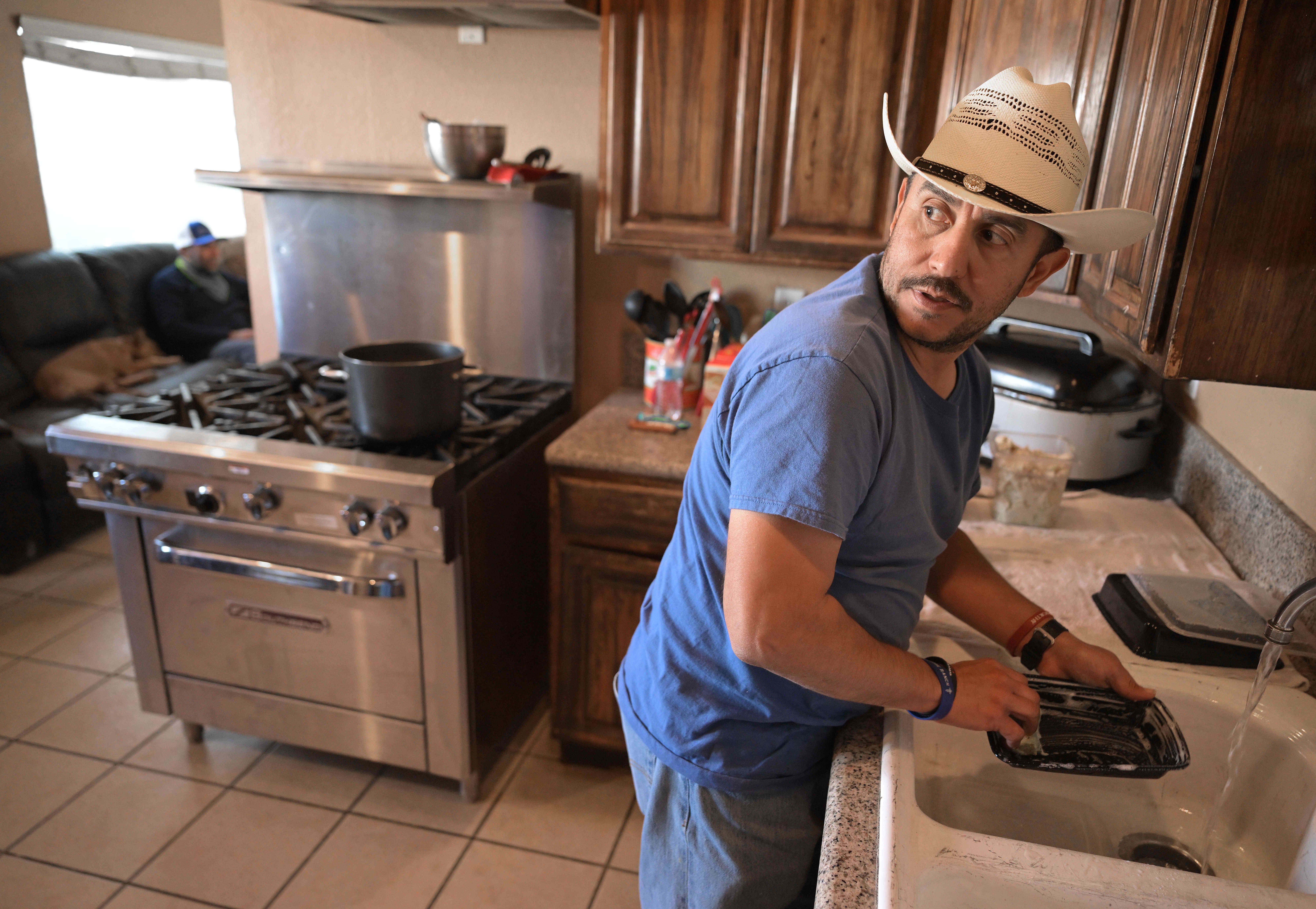 River’s Edge Ranch ârancherâ Rodney Mora, from Fontana, washes dishes...