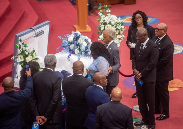 Rev. Al Sharpton walks with Audrey Jones to pay respects to her brother, Steven Jones, as he lies in his coffin before services at The First Cathedral in Bloomfield on Thursday, March 26, 2026. (Aaron Flaum/Hartford Courant)