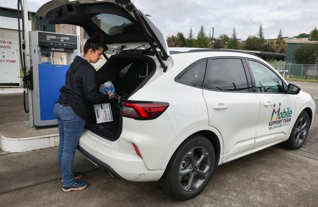 Behavioral health clinician Jessica Kastrup organizes a Sonoma County Mobile Health Support Team vehicle while refueling at a county facility in Santa Rosa on Wednesday, February 25, 2026. (Christopher Chung/The Press Democrat)