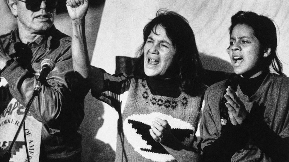 FILE - United Farm Workers leader Dolores Huerta, center, leads a rally in San Francisco's Mission District on Nov. 19, 1988, along with Howard Wallace, president of the San Francisco chapter of the UFW, left, and Maria Elena Chavez, 16, the daughter of Cesar Chavez, right, as part of a national boycott of what the UFW claims is the dangerous use of pesticides on table grapes. (AP Photo/Court Mast, File)