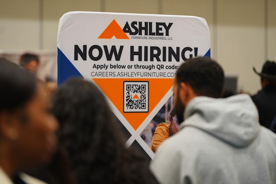 A sign with information about employment is displayed during a job fair in Dallas, on Jan. 14, 2026. (AP Photo/LM Otero)